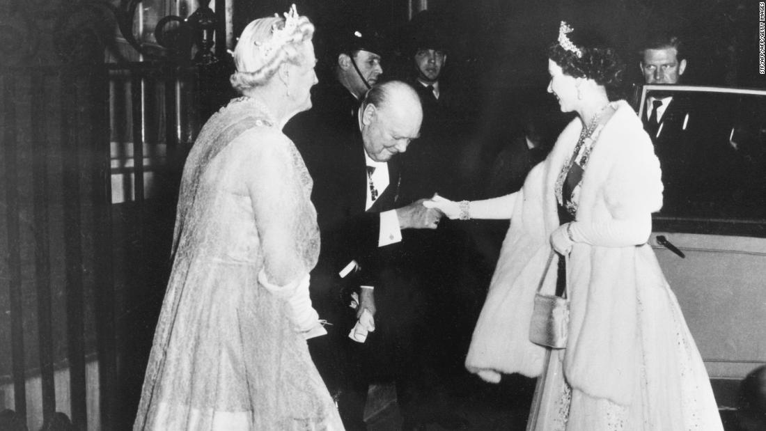 Winston Churchill kisses Queen Elizabeth II's (R) hand as she leaves 10 Downing Street in 1955.