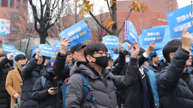 Protesters demand fair trials for men accused of sexual assault at an anti-feminist rally in Seoul, November 2018.