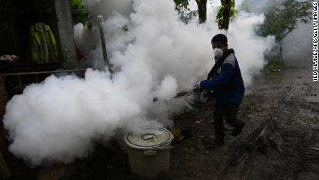 A municipal employee operates a fogging machine to kill mosquito larvae to fight the spread of dengue at a village in the town of Antipolo, Rizal province, east of Manila.