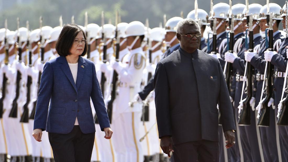 Solomon Islands President Manasseh Sogavare (R) and Taiwan President Tsai Ing-wen (L) inspect an honour guard during a welcome ceremony in Taipei on September 26, 2017.