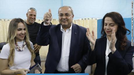 Israeli Arab politician Ahmed Tibi stands between his daughter (L) and wife as he casts his vote during Israel&#39;s parliamentary elections on April 9, 2019 in in the northern Israeli town of Taiyiba. - Israelis voted today in a high-stakes election that will decide whether to extend Prime Minister Benjamin Netanyahu&#39;s long right-wing tenure despite corruption allegations or to replace him with an ex-military chief new to politics. (Photo by Ahmad GHARABLI / AFP)        (Photo credit should read AHMAD GHARABLI/AFP/Getty Images)