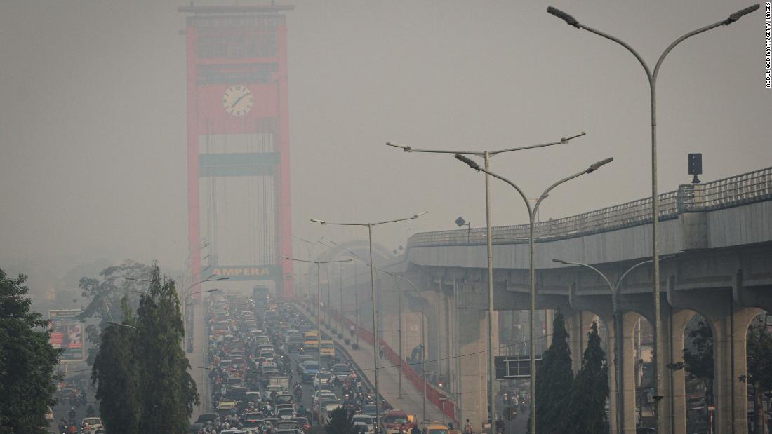 Motorists commute on a hazy day in Palembang on September 18, 2019. 