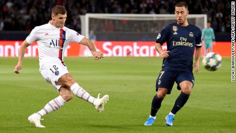 Paris Saint-Germain defender Thomas Meunier (L) challenges Real Madrid&#39;s Eden Hazard.