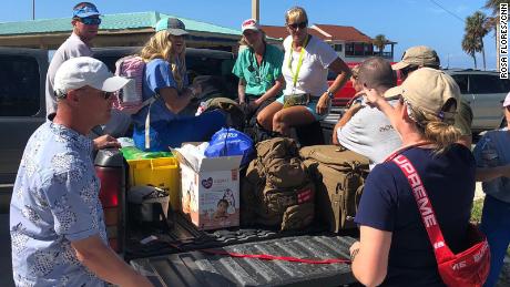 Brittany Reidy, right, debriefs her team in Freeport before heading to East Grand Bahama.