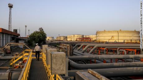 Storage tanks stand beyond pipework at the Vadinar Refinery complex operated by Nayare Energy Ltd., formerly known as Essar Oil Ltd. and now jointly owned by Rosneft Oil Co. and Trafigura Group Pte., near Vadinar, Gujarat, India, on Thursday, April 26, 2018. The refinery was the crown jewel in a blockbuster $13 billion acquisition that, at the time, represented the largest foreign direct investment in India&#39;s history. The deal marked Trafigura&#39;s coming of age. Photographer: Dhiraj Singh/Bloomberg via Getty Images