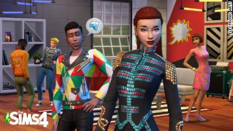 Sims characters in the game &quot;Sims 4&quot; pose in their Moschino outfits.