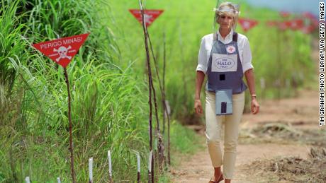 Diana, wearing protective body armour and a visor, visits a minefield being cleared by the charity Halo in Huambo, Angola in 1997. 