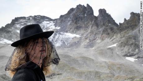 A woman takes part in a ceremony to mark the &quot;death&quot; of Switzerland&#39;s Pizol glacier on Sunday. 