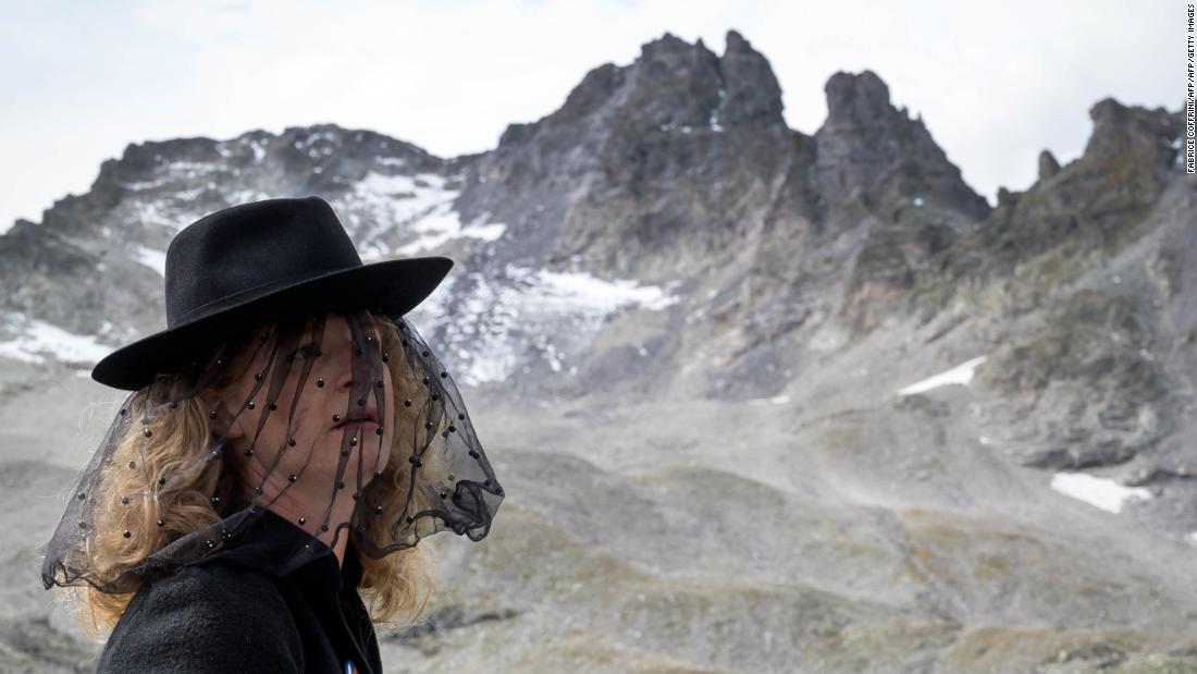 A woman takes part in a ceremony to mark the "death" of Switzerland's Pizol glacier on Sunday. 