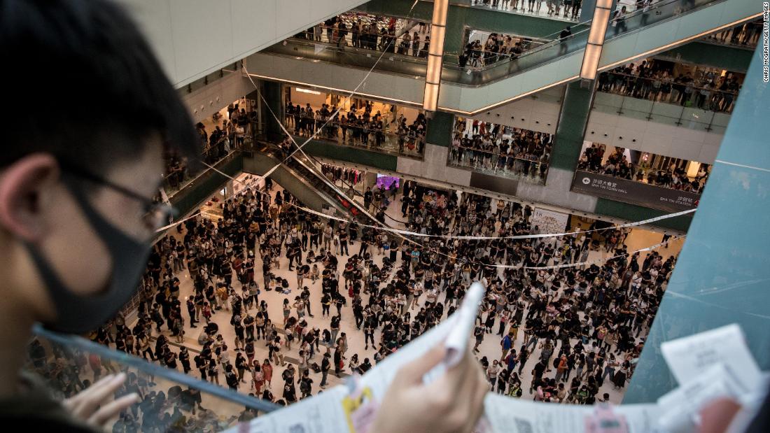 Pro-democracy protesters sing songs and chant slogans during a rally inside a shopping mall in Shatin on September 22.