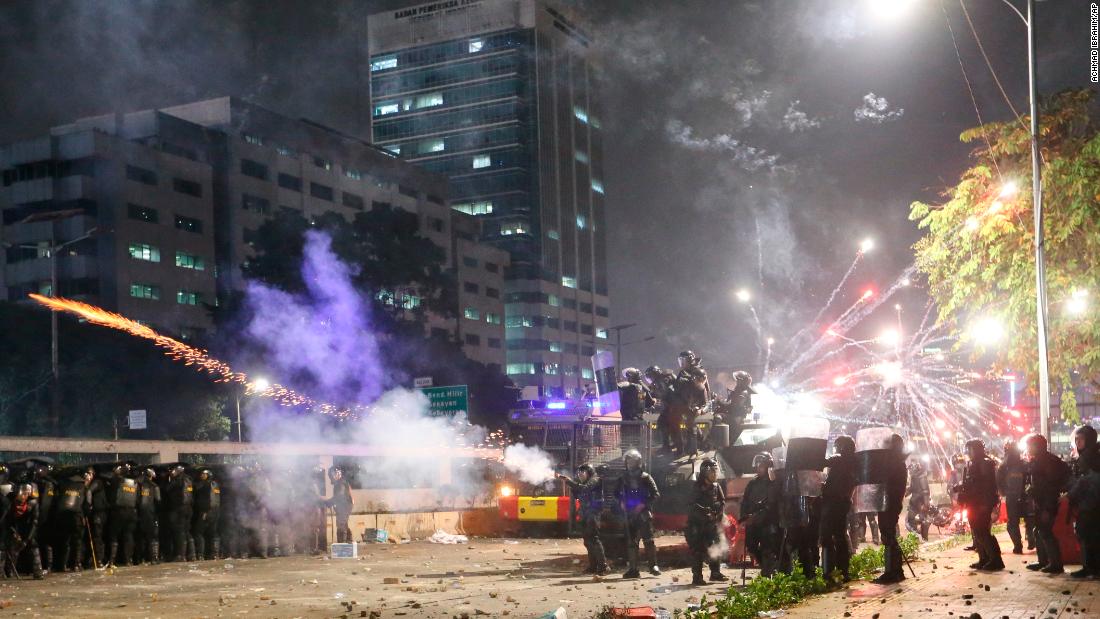 Indonesian riot police fire tear gas to disperse student protesters during a clash outside parliament in Jakarta, Indonesia, on September 24, 2019. 