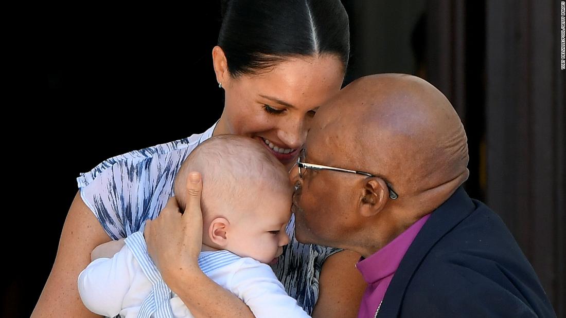 Tutu kisses Archie, the son of Britain&#39;s Prince Harry and Meghan, the Duchess of Sussex, in September 2019. The royal family was visiting South Africa.