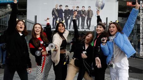 Fans react as they arrive for a concert of the South Korean K-pop boy band BTS at the Stade-de-France stadium in Saint-Denis, on the outskirts of Paris, on June 7, 2019. 