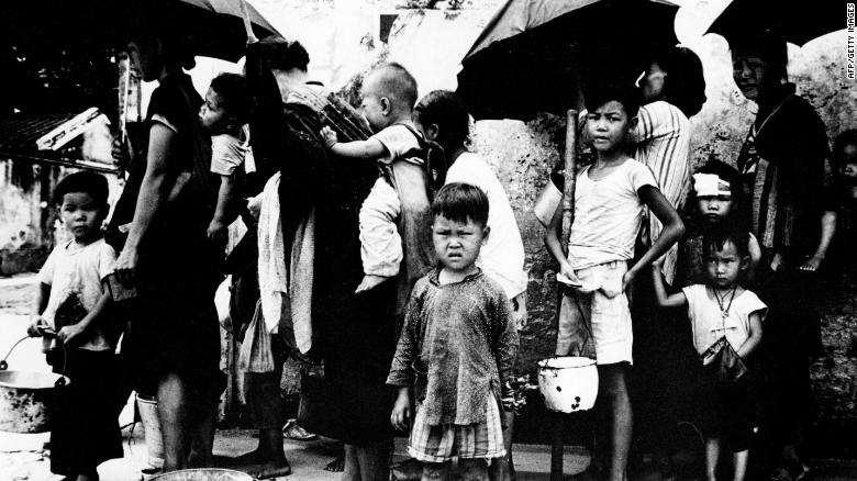 Chinese refugees queuing for a meal in Hong Kong in May 1962, after fleeing mass famine on the mainland.