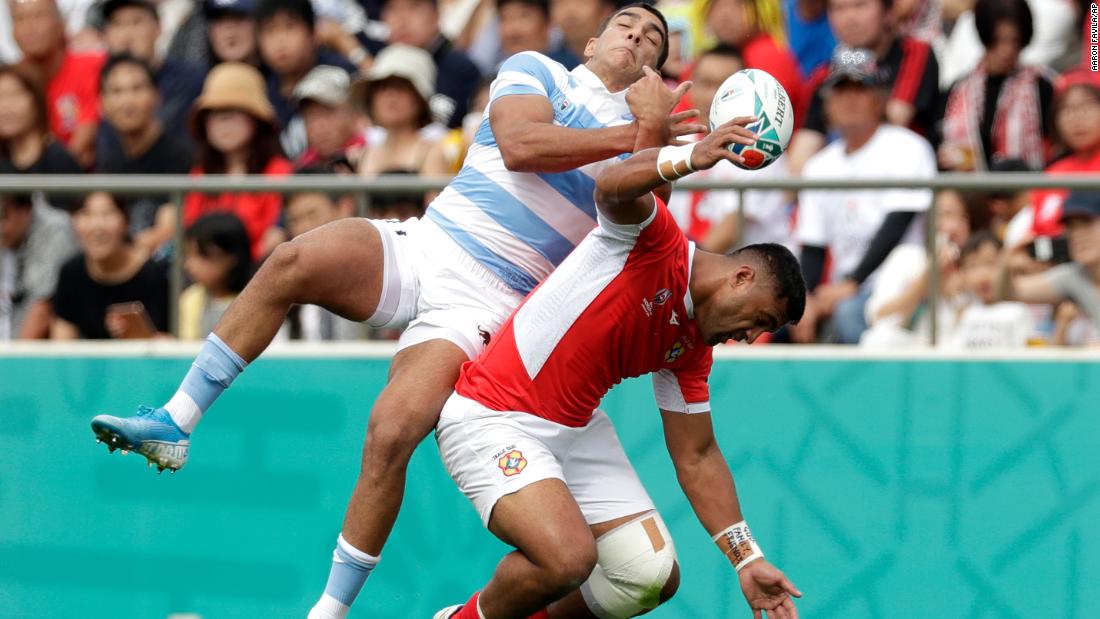 Argentina&#39;s Santiago Carreras and Tonga&#39;s Viliami Lolohea compete for the ball during the Rugby World Cup Pool C game.