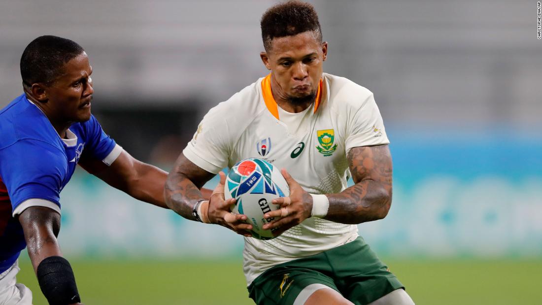 South Africa&#39;s Elton Jantjies runs past Namibia&#39;s Eugene Jantjies during the one-sided match.