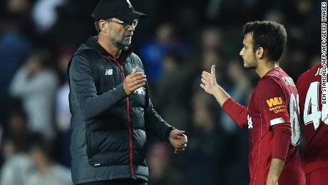 Liverpool&#39;s manager Jurgen Klopp celebrates with Spanish midfielder Pedro Chirivella at the final whistle of the English League Cup win over MK Dons. 