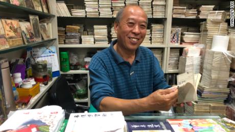 Ma sitting in his &quot;lianhuanhua&quot; comic book store in Beijing in September, surrounded by his life&#39;s work.