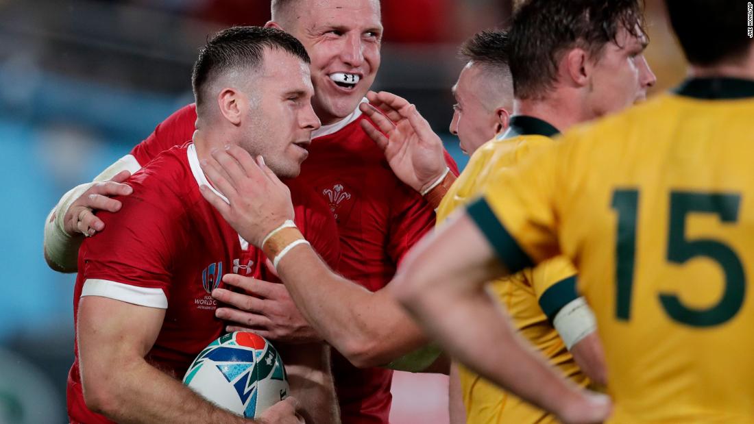 Wales&#39; Gareth Davies (left) is congratulated by teammate Hadleigh Parkes after scoring his crucial interception try during a 29-25 win over Australia in the Rugby World Cup Pool D game at Tokyo Stadium.
