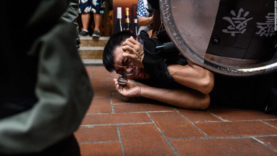 A man is detained by Hong Kong police during a protest in the Causeway Bay shopping district on Sunday, September 29.