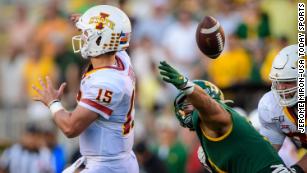 Marcedes Lewis of the Green Bay Packers hurdles Nate Gerry of the