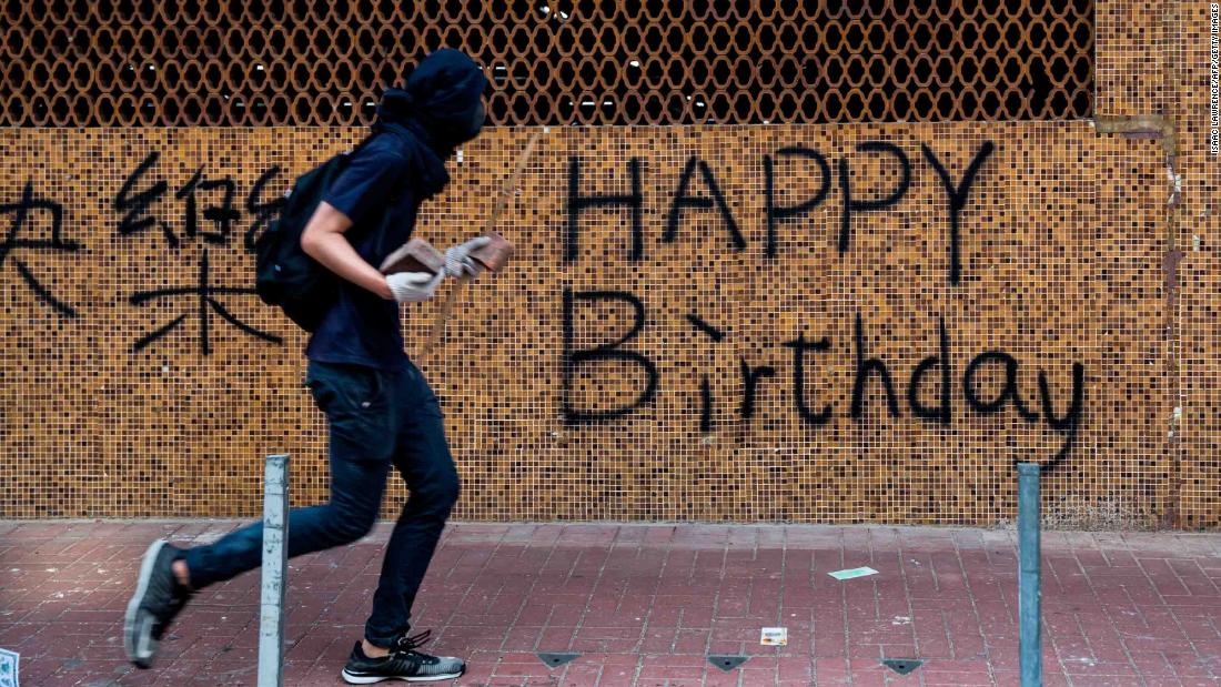 A protester is seen carrying rocks on a street on October 1. While events in Beijing were being held to mark the &lt;a href=&quot;https://edition.cnn.com/2019/10/01/world/gallery/china-70th-anniversary/index.html&quot; target=&quot;_blank&quot;&gt;70th anniversary of the founding of the People&#39;s Republic of China,&lt;/a&gt; demonstrators rallied throughout Hong Kong.