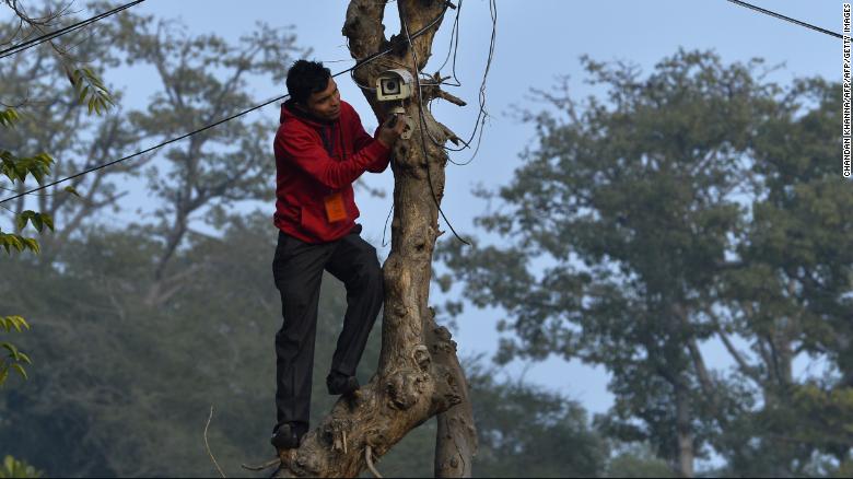 An Indian technician checks the CCTV camera at the roadside near the Presidential Palace as preparations for the nation&#39;s Republic Day parade take place in New Delhi.