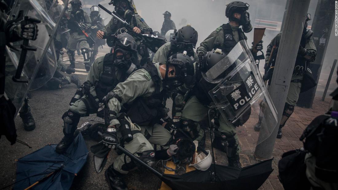 Police tackle and arrest pro-democracy protesters during clashes on October 1. 