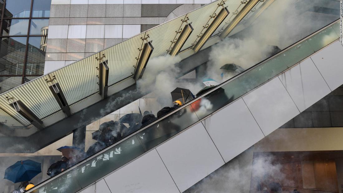 Protesters react after police fired tear gas near the central government offices in Hong Kong's Admiralty area on October 1.