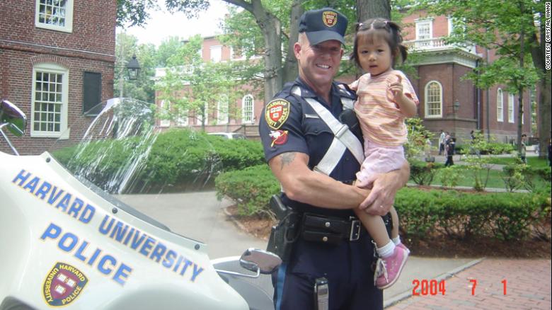 Crystal Wang was 3 years old when her father snapped a picture of her in the arms of Marren beside his bike.