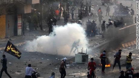 Iraqi police fire teargas at protesters during a demonstration against state corruption, failing public services and unemployment at Tayaran square in Baghdad on October 2, 2019. - Iraq&#39;s president and the United Nations urged security forces to show restraint after two protesters were killed in clashes with police that other top officials blamed on &quot;infiltrators.&quot; (Photo by AHMAD AL-RUBAYE / AFP) (Photo by AHMAD AL-RUBAYE/AFP via Getty Images)