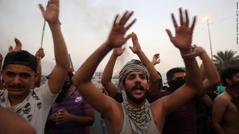 Iraqi protesters chant during a demonstration against state corruption, failing public services and unemployment in Baghdad on October 2, 2019.
