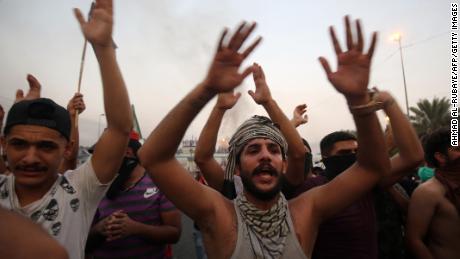 Iraqi protesters chant during a demonstration against state corruption, failing public services and unemployment in Baghdad on October 2, 2019.