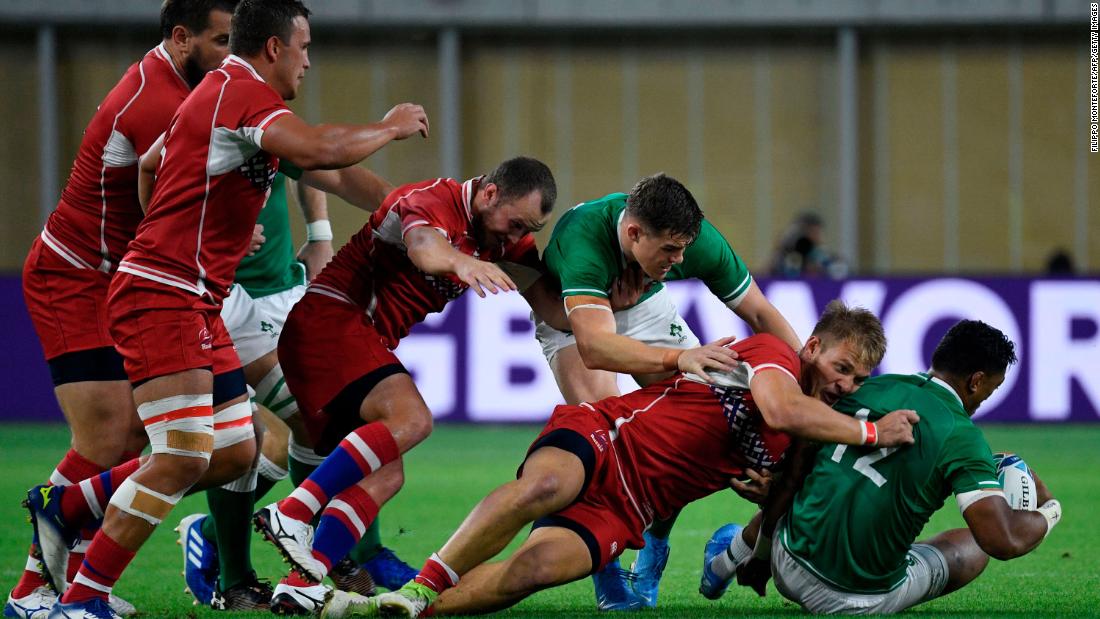 Ireland&#39;s centre Bundee Aki (right) felt the force of Russian opposite number Kirill Golosnitskiy during the Pool A match.