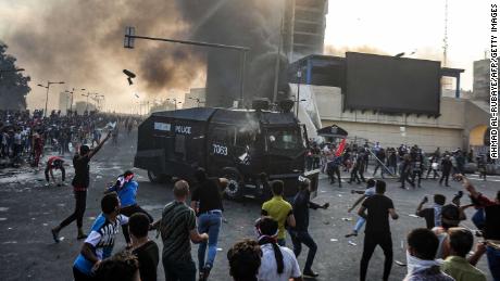 Protesters clash with an Iraqi riot police vehicle during a demonstration in Baghdad on Monday.