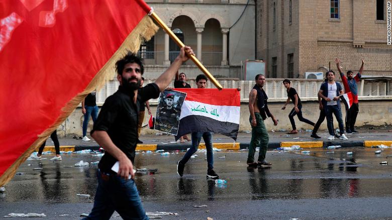 Protestors wave flags during a protest in Tahrir Square on October 1.