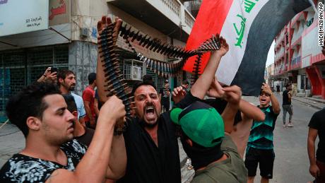 Protesters hold bullets they say belonged to Iraqi police during a protest in Baghdad on Tuesday.