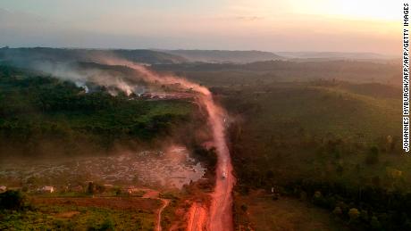 TOPSHOT - In this aerial view the red dust of the BR230 highway, known as &quot;Transamazonica&quot;, mixes with fires at sunset in the agriculture town of Ruropolis, Para state, northen Brazil, on September 6, 2019. - Presidents and ministers from seven Amazon countries met in Colombia on Friday to agree on  measures to protect the world&#39;s biggest rainforest, under threat from wildfires and rampant deforestation. The summit took place in the wake of an international outcry over months of raging fires that have devastated swaths of the Amazon in Brazil and Bolivia. (Photo by Johannes MYBURGH / AFP)        (Photo credit should read JOHANNES MYBURGH/AFP/Getty Images)