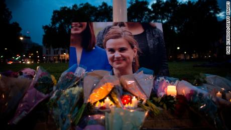 Flowers surround a picture of Jo Cox during a vigil in Parliament Square on June 16, 2016 in London. Cox was murdered in her electoral district in 2016.   