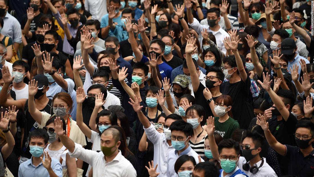 Pro-democracy demonstrators hold up their hands to symbolize their five demands during a rally on October 4.