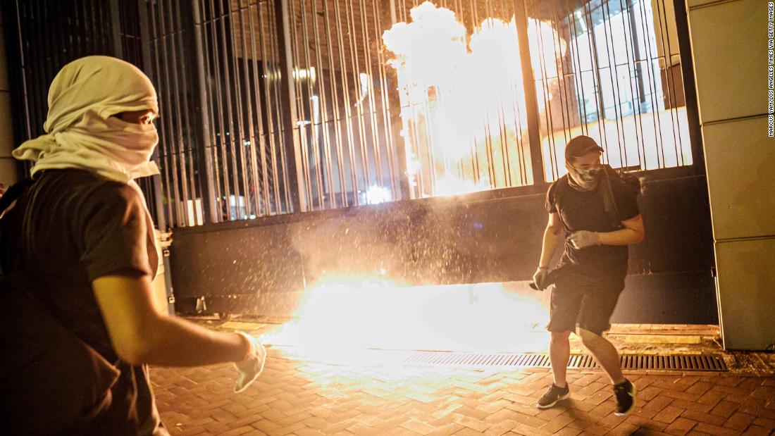 Protesters throw petrol bombs at the gate to the Tsuen Wan police station on Wednesday, October 2.