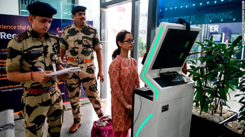 A passenger stands as she registers her personal details at a facial recognition counter at the Rajiv Gandhi International Airport in Hyderabad, on July 26, 2019. 