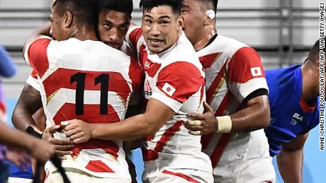 Japan&#39;s Timothy Lafaele celebrates with teammates after scoring a crucial first half try  during the Rugby World Cup Pool A match against Samoa at the Toyota Stadium.