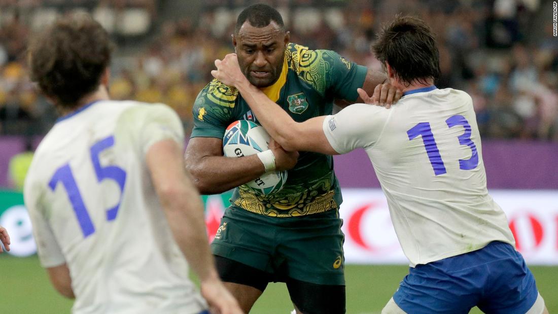 Australia&#39;s Tevita Kuridrani is tackled by Uruguay&#39;s Tomas Inciarte during the Rugby World Cup Pool D game at Oita Stadium.