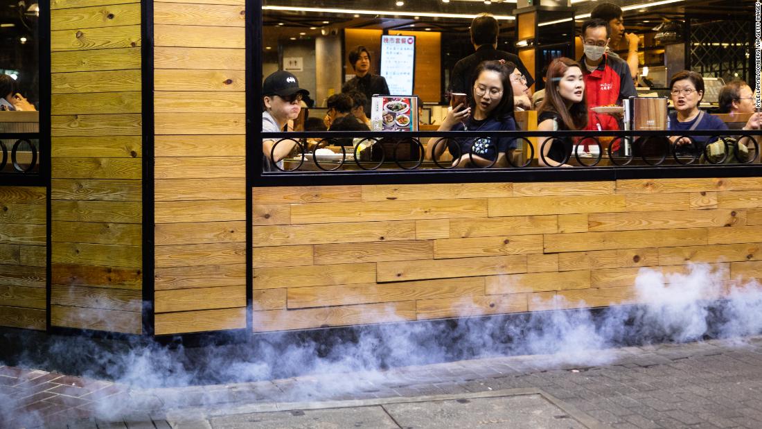 Police deploy tear gas outside a restaurant during a protest in the Causeway Bay district.