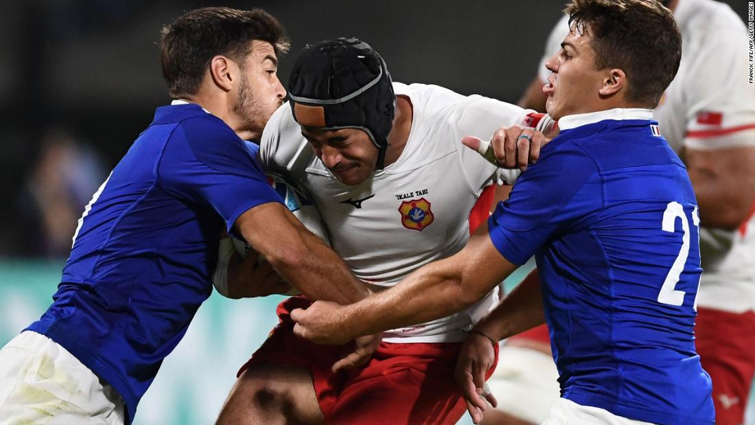 Tonga&#39;s centre Mali Hingano (C) is held up by France&#39;s  fly-half Romain Ntamack (L) and France&#39;s scrum-half Antoine Dupont (R).