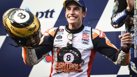 Spain&#39;s Marc Marquez celebrates on the podium after winning the Thailand MotoGP to clinch his sixth world title in the premier class and eighth overall. 