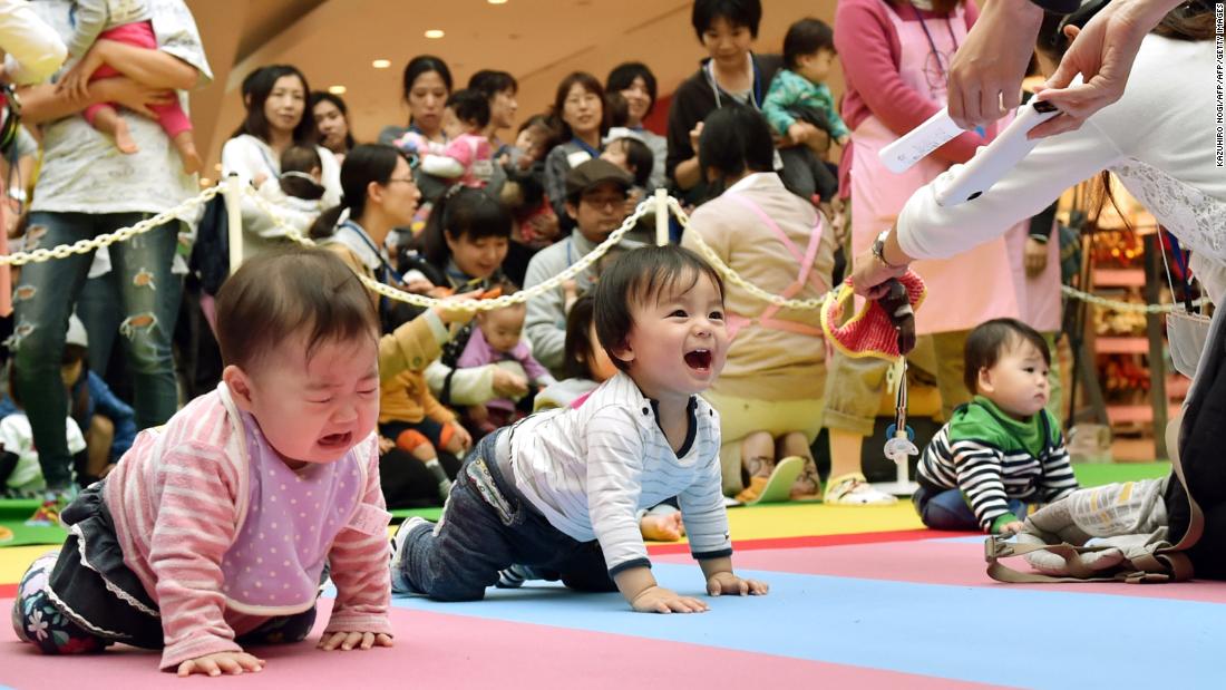 Babies compete in a crawling competition in Kanagawa prefecture in 2015. In Japan, more women are delaying having children or forgoing having them altogether, which has led to a fertility crisis.