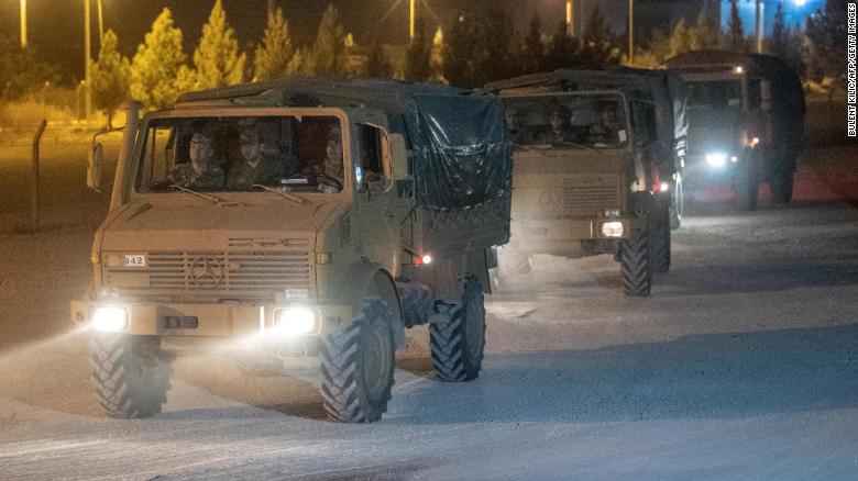 Turkish army soldiers drive towards the border with Syria near Akcakale in Sanliurfa province on October 8, 2019.