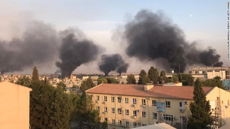 A photo taken from Turkey's Sanliurfa province shows smoke rising at the site of Ras al-Ain.